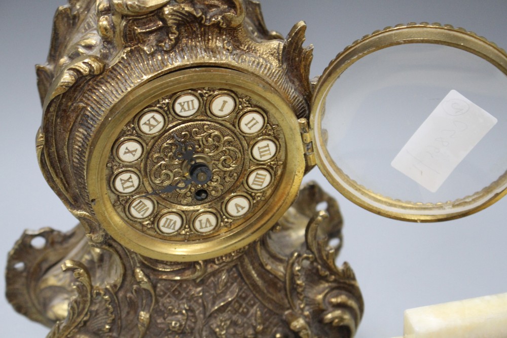 A Bayard two colour onyx mantel timepiece, height 15cm and a gilt metal mantel timepiece, height 42cm